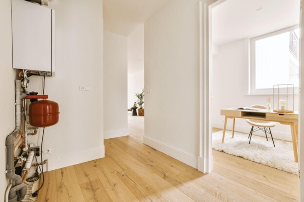 Wall-mounted boiler in a modern home representing boiler sizing and choosing the correct heating output.