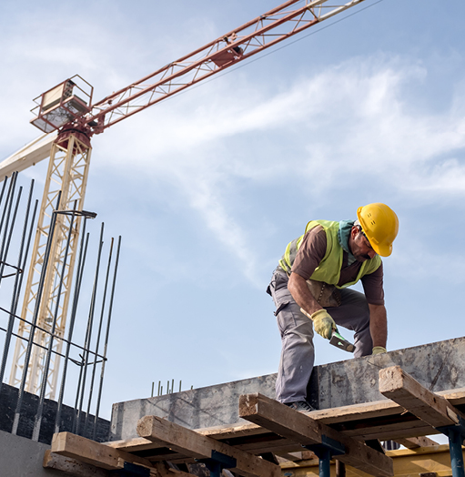 Construction site worker hammering in a nail