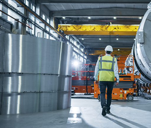 mechanical site engineer walking through warehouse