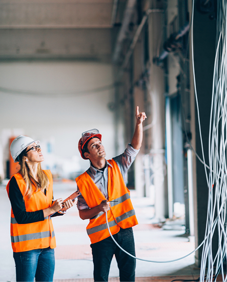 Electrical Engineers pointing at loose cabling on construction site