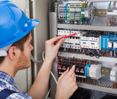 Electrical engineer screwing in electric cables