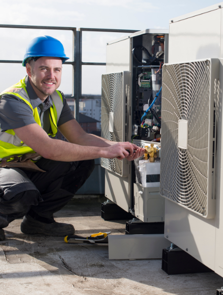 Mechanical engineer on a rooftop installing air conditioning unit